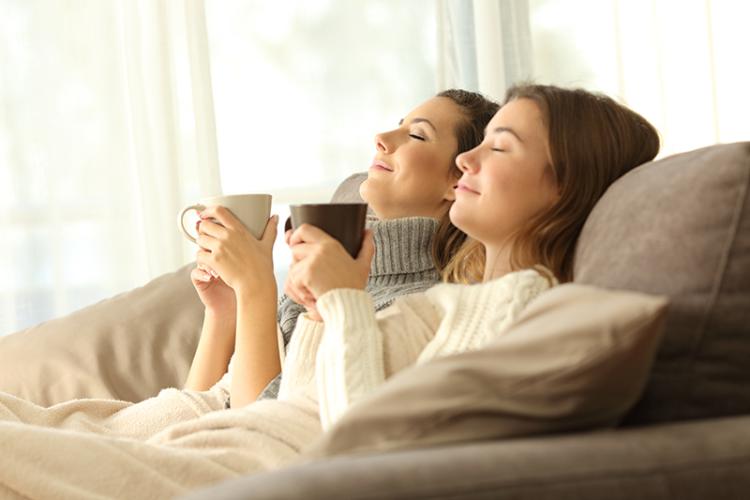 Family cozying up on the couch.