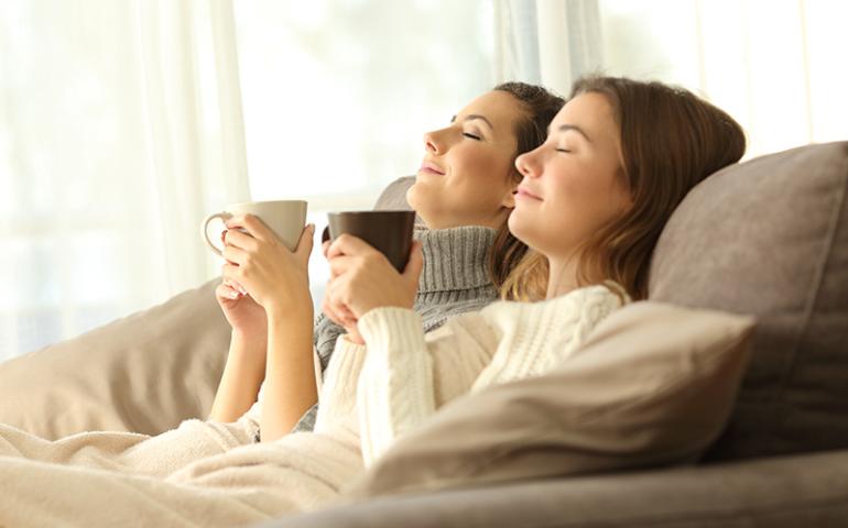 Family cozying up on the couch.