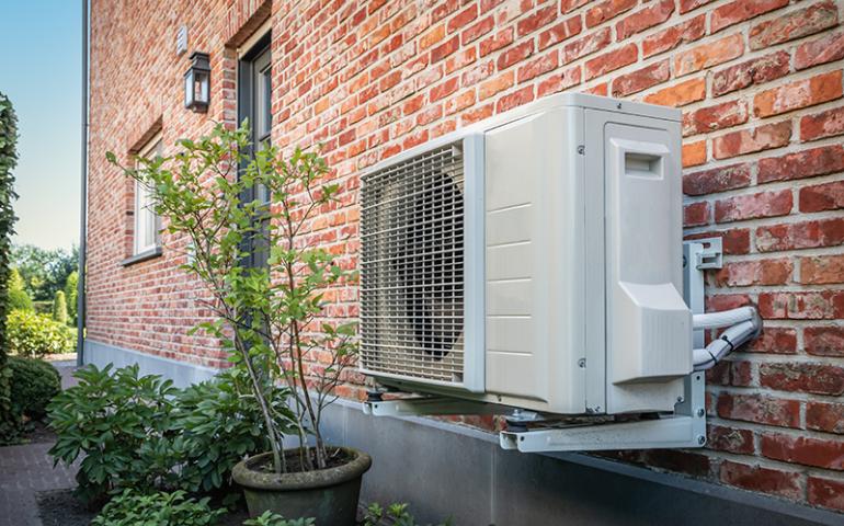 Outdoor heat pump on the facade of home.