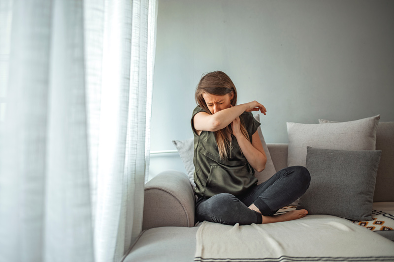 A woman inside her home suffering from sick building syndrome.