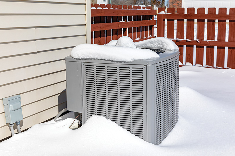 AC unit covered in snow