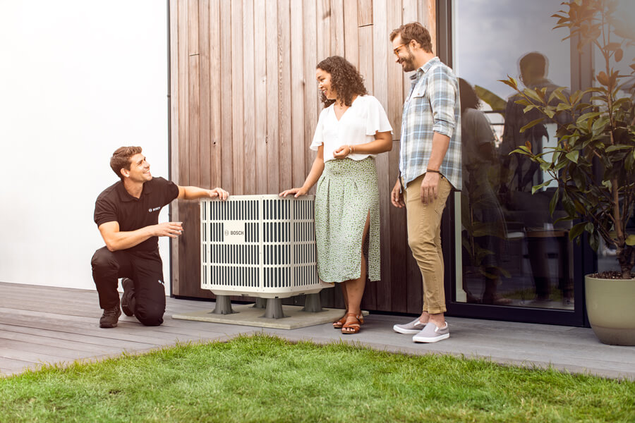 HVAC Technician reviewing new A/C unit installation