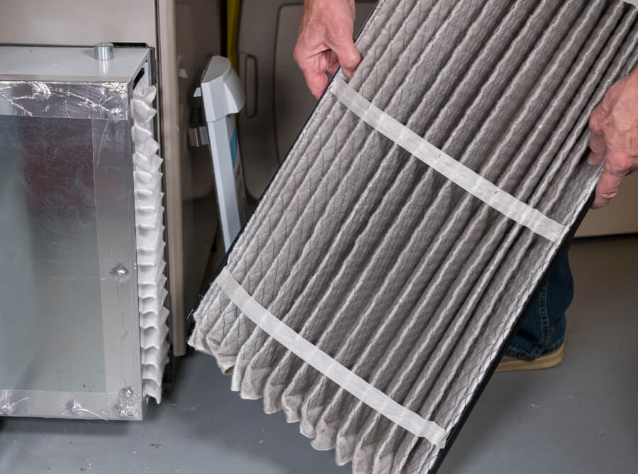 Furnace air filter being replaced