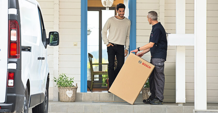 Homeowner receiving a Bosch heating unit from a Service Express technician