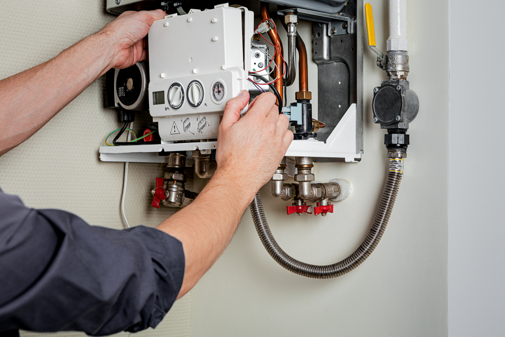 HVAC technician repairing a home boiler system